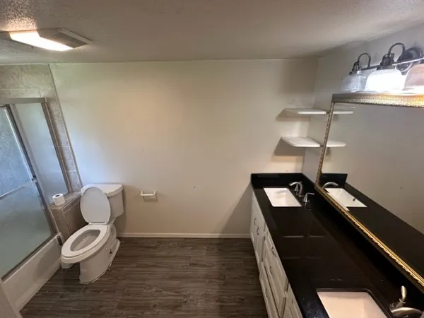 a bathroom with a toilet sink and mirror