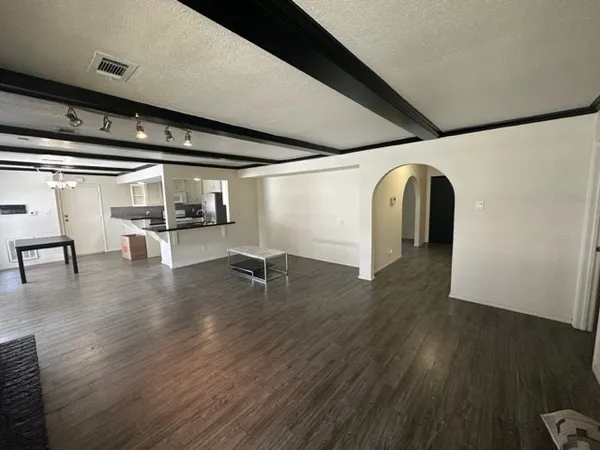 a view of a room with wooden floor