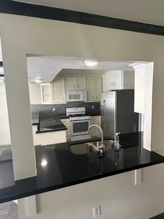 a kitchen with a sink and refrigerator