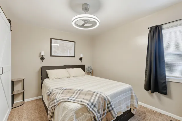 a bedroom with a bed and a television