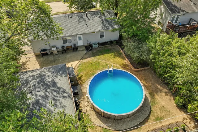 a view of a swimming pool with an outdoor space and seating area