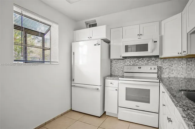 a white refrigerator freezer and a stove top oven