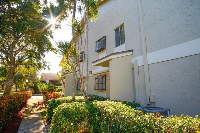 a view of a pathway along with potted plants
