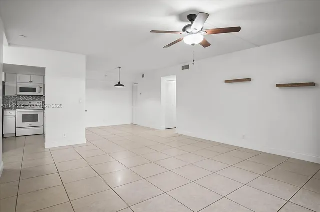 a view of a kitchen with marble kitchen and stainless steel appliances