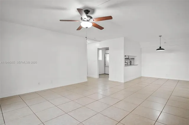a view of a livingroom with a ceiling fan and wooden floor