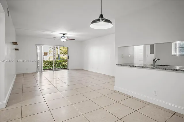 a view of a kitchen with a sink and chandelier