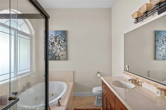 a bathroom with a tub a sink and a toilet