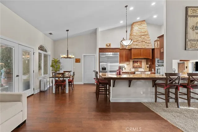 a kitchen with lots of counter and chairs