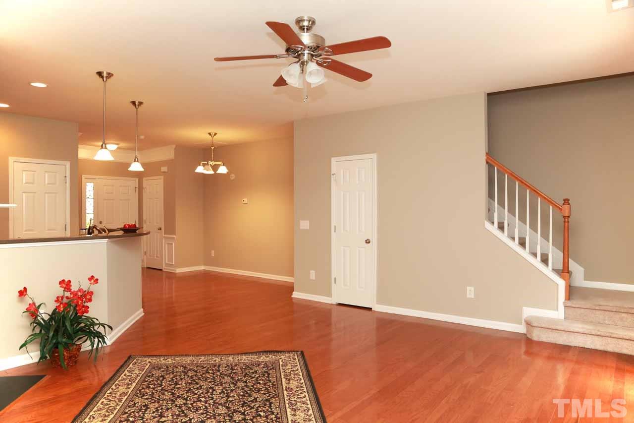 7114 Racine Way Raleigh, NC 27615 - Photo 3 of 23 a view of an empty room with a window and wooden floor