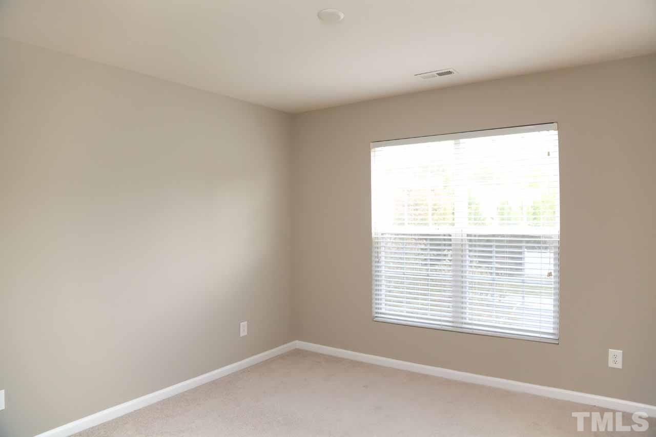 7114 Racine Way Raleigh, NC 27615 - Photo 8 of 23 a view of an empty room with a window