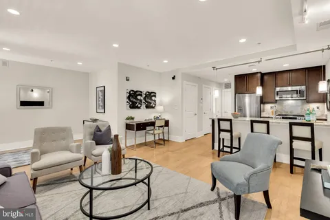 a living room with furniture and kitchen view