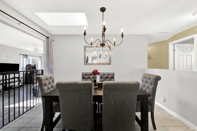 a view of a dining room with furniture and chandelier