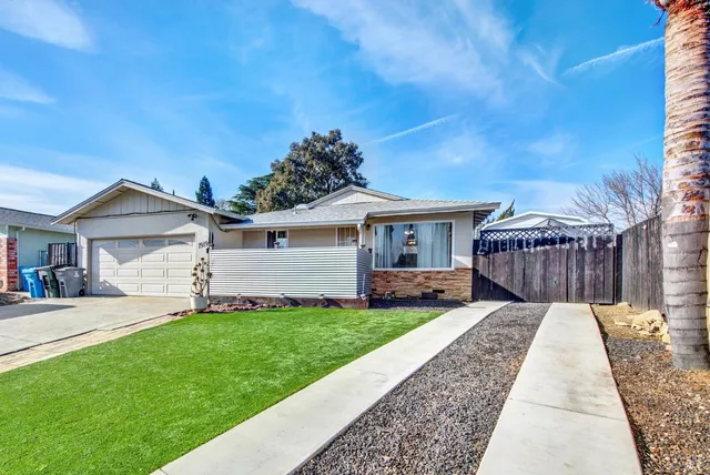 a front view of a house with a yard and pathway