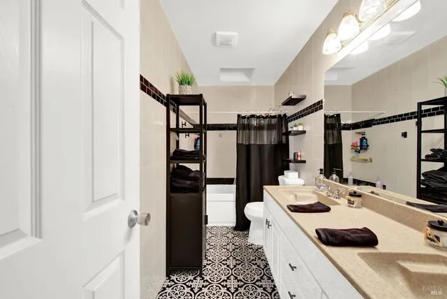 a kitchen with a sink a refrigerator and cabinets