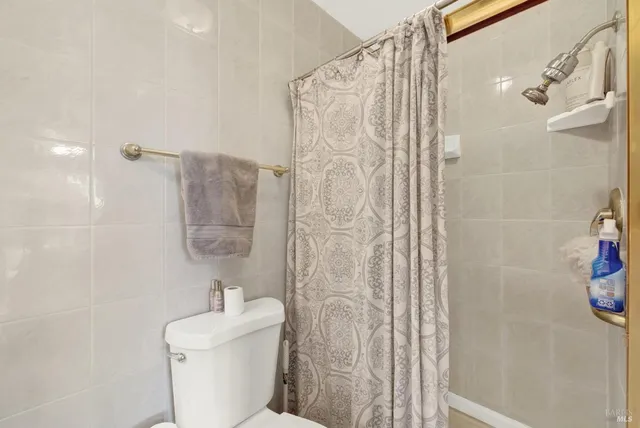 a bathroom with a toilet sink and shower