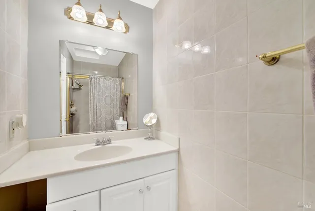 a bathroom with a sink vanity and a mirror