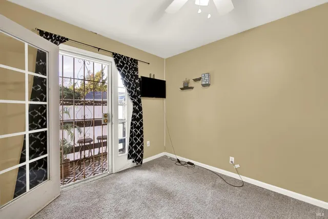 a view of an empty room with a window and storage