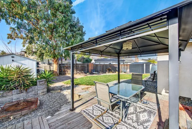 a patio with a yard table and chairs