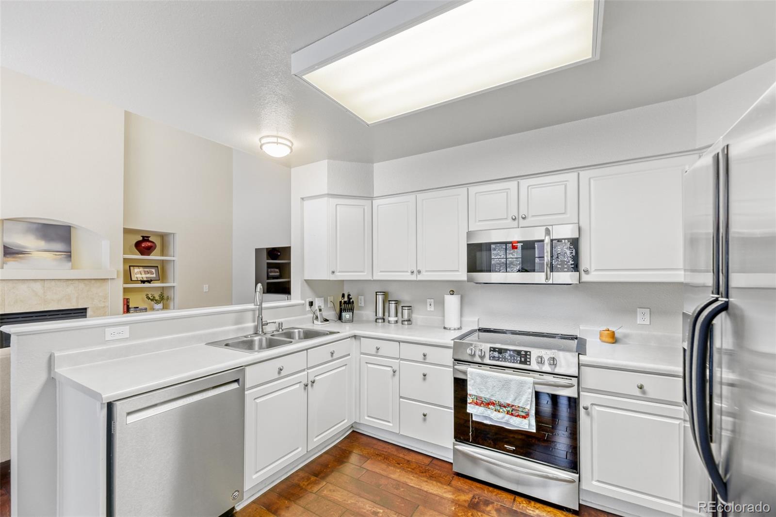 456 Bexley Lane Highlands Ranch, CO 80126 - Photo 11 of 28 a kitchen with appliances a sink and cabinets