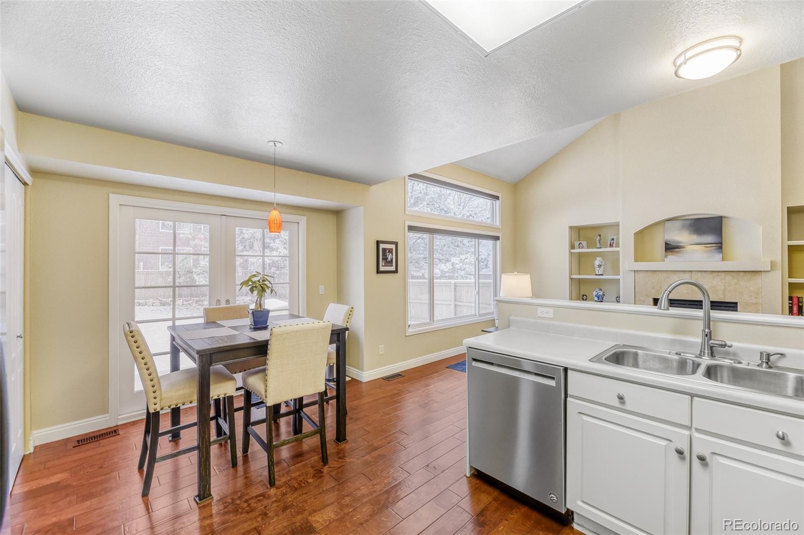 456 Bexley Lane Highlands Ranch, CO 80126 - Photo 12 of 28 a kitchen with a table chairs and wooden floor