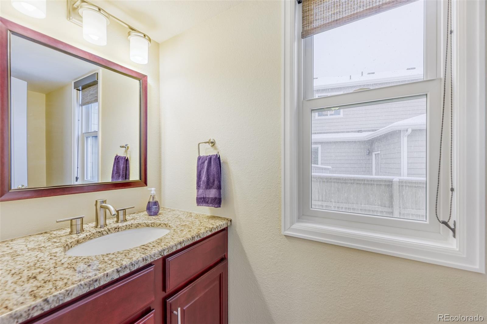 456 Bexley Lane Highlands Ranch, CO 80126 - Photo 14 of 28 a bathroom with a granite countertop sink and a mirror