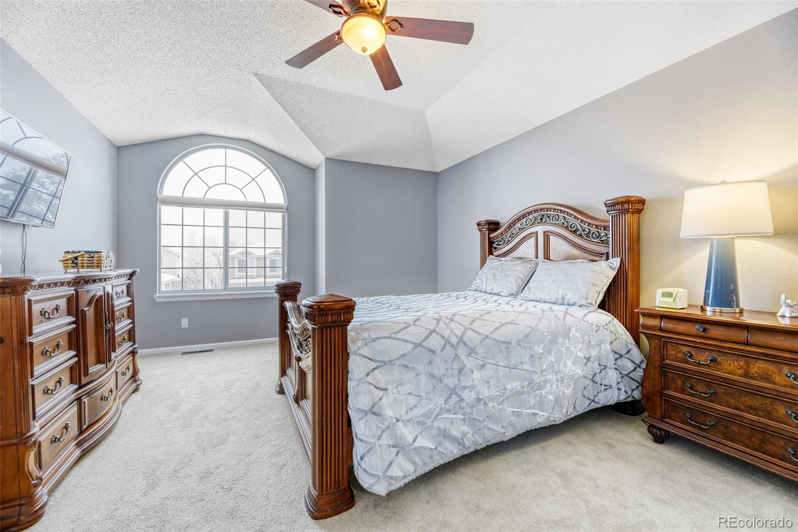 456 Bexley Lane Highlands Ranch, CO 80126 - Photo 16 of 28 a bedroom with a bed and a chandelier