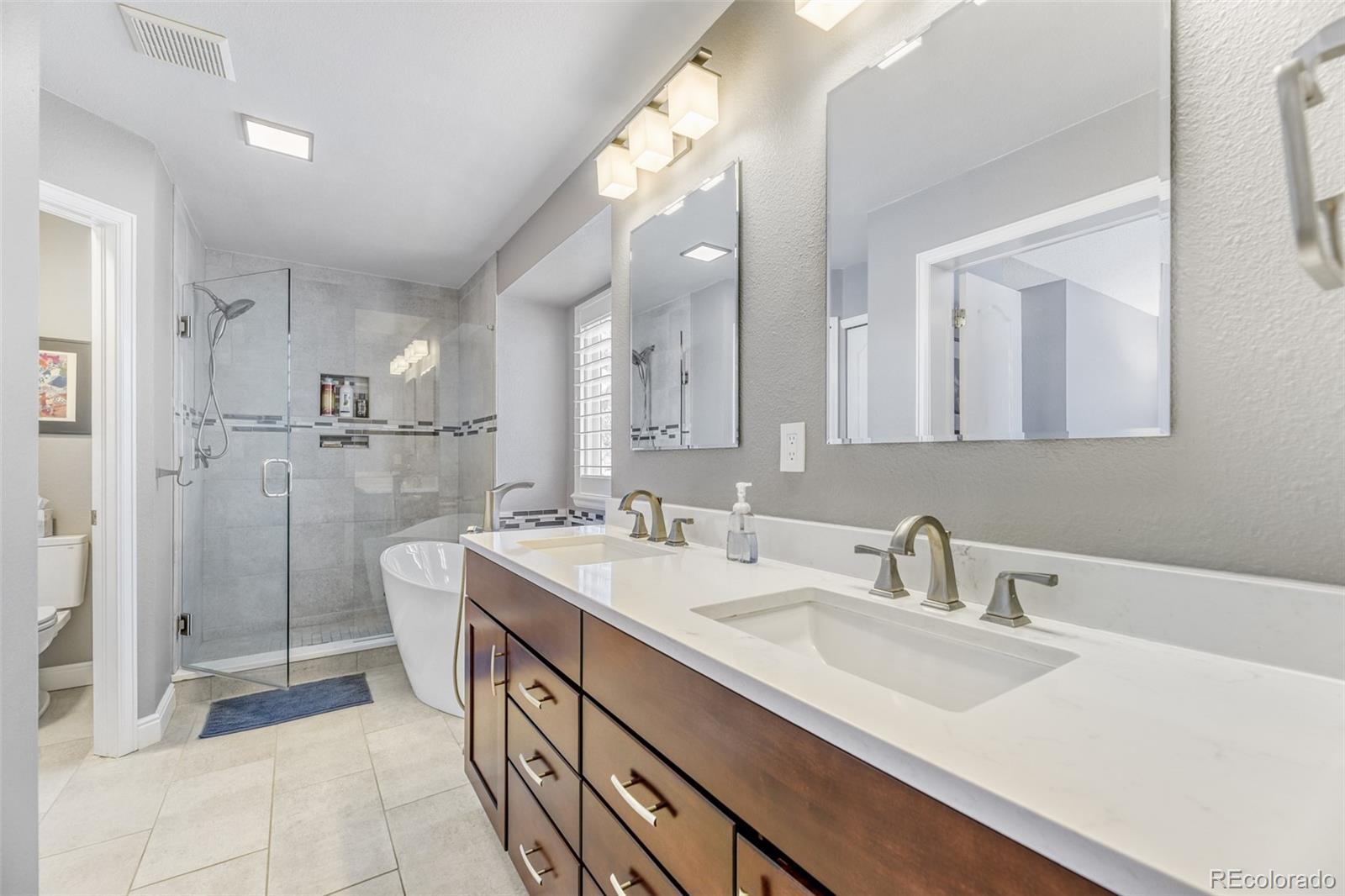 456 Bexley Lane Highlands Ranch, CO 80126 - Photo 17 of 28 a bathroom with a double vanity sink mirror and shower