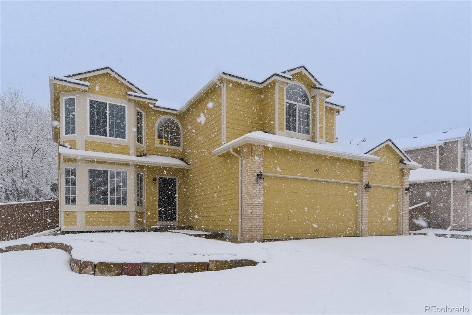 456 Bexley Lane Highlands Ranch, CO 80126 - Photo 2 of 28 a view of a white house with a large windows next to a yard