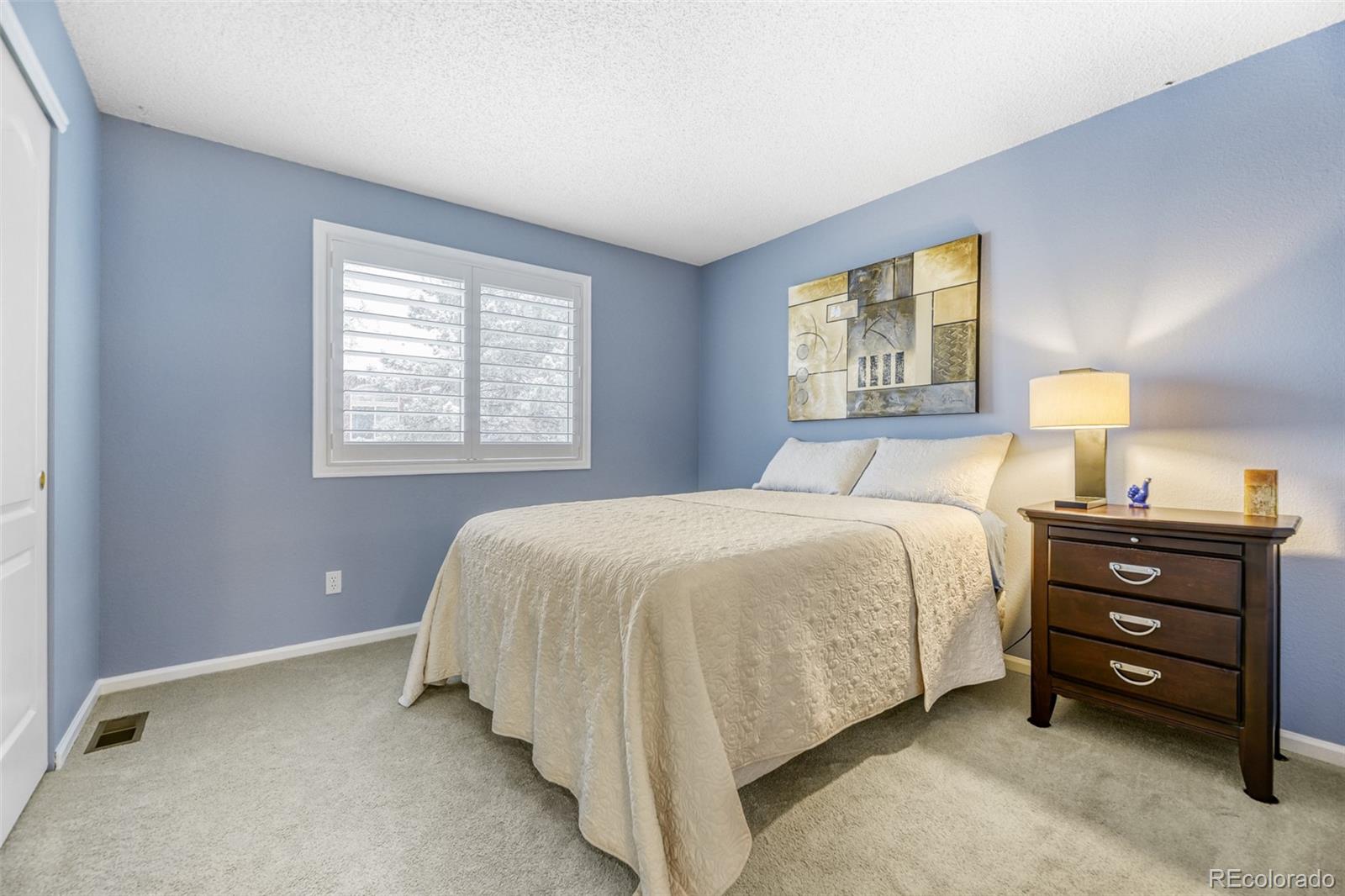 456 Bexley Lane Highlands Ranch, CO 80126 - Photo 21 of 28 a spacious bedroom with a bed and a window