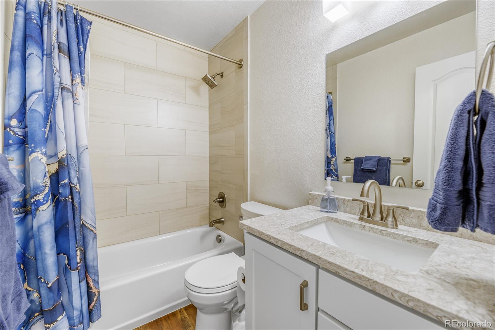 456 Bexley Lane Highlands Ranch, CO 80126 - Photo 22 of 28 a bathroom with a granite countertop sink toilet and shower