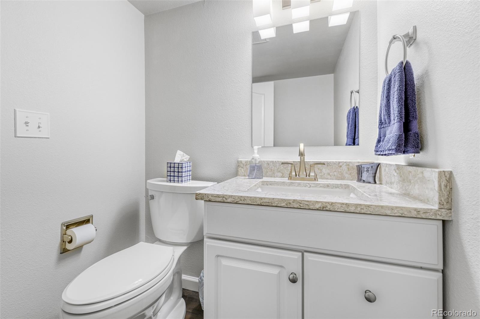 456 Bexley Lane Highlands Ranch, CO 80126 - Photo 24 of 28 a bathroom with a granite countertop toilet sink and mirror