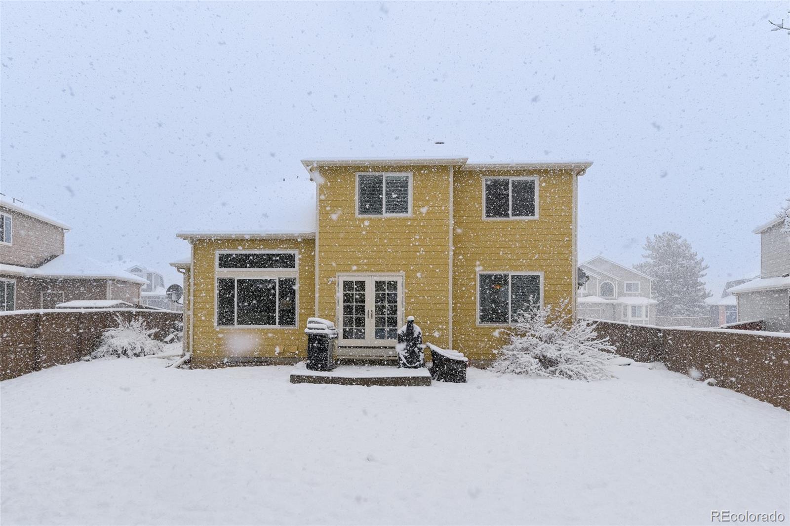 456 Bexley Lane Highlands Ranch, CO 80126 - Photo 25 of 28 a view of a house with a yard and garage