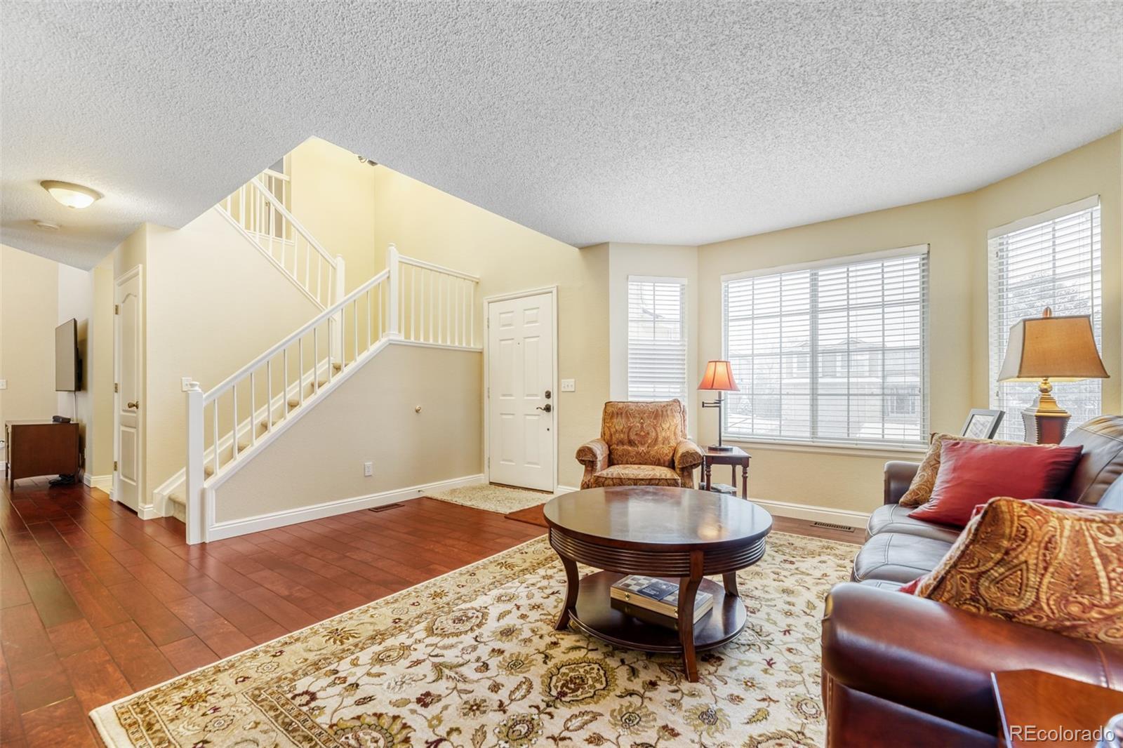 456 Bexley Lane Highlands Ranch, CO 80126 - Photo 5 of 28 a living room with furniture and a table