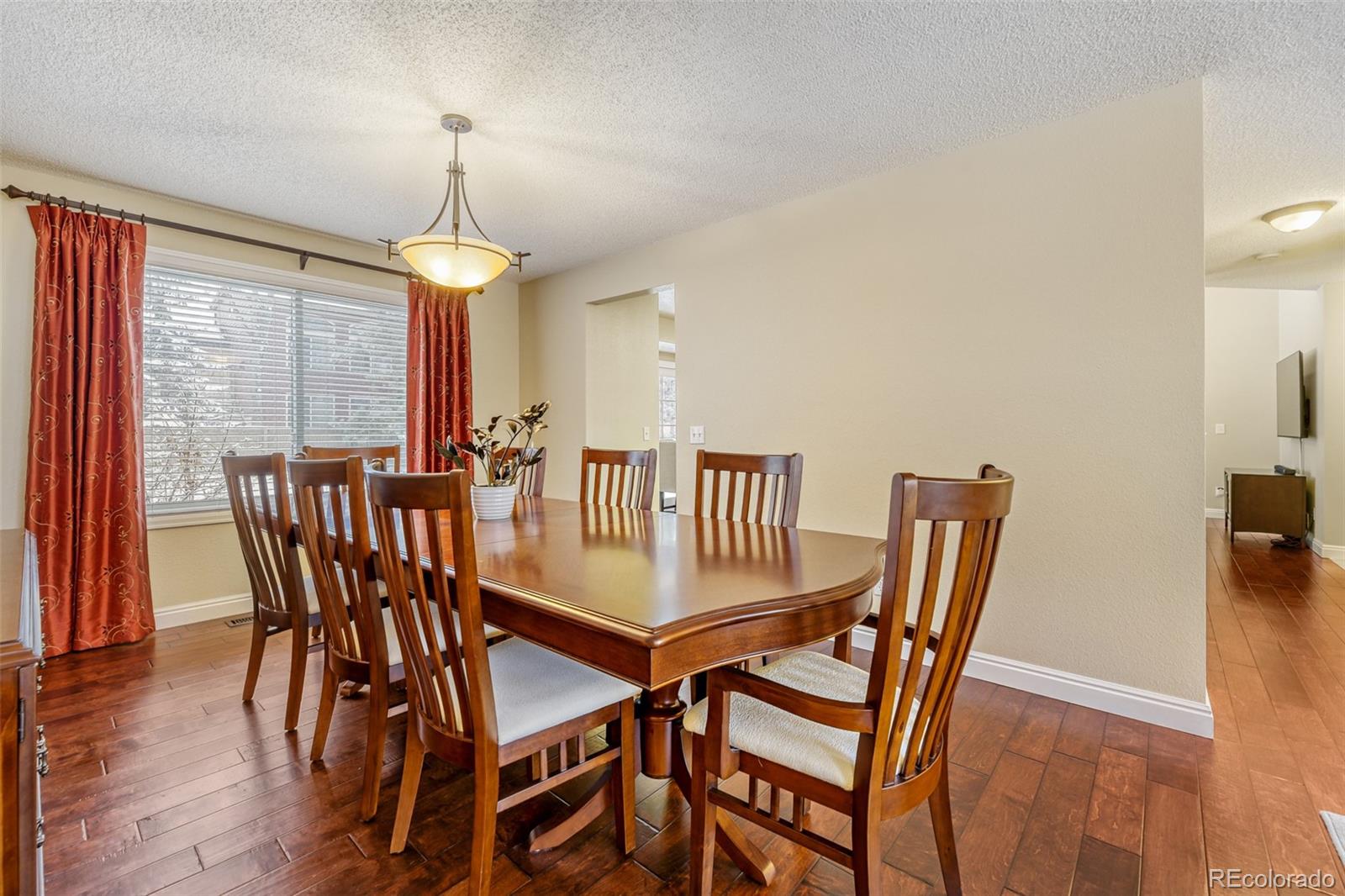 456 Bexley Lane Highlands Ranch, CO 80126 - Photo 9 of 28 a view of a dining room with furniture window and wooden floor