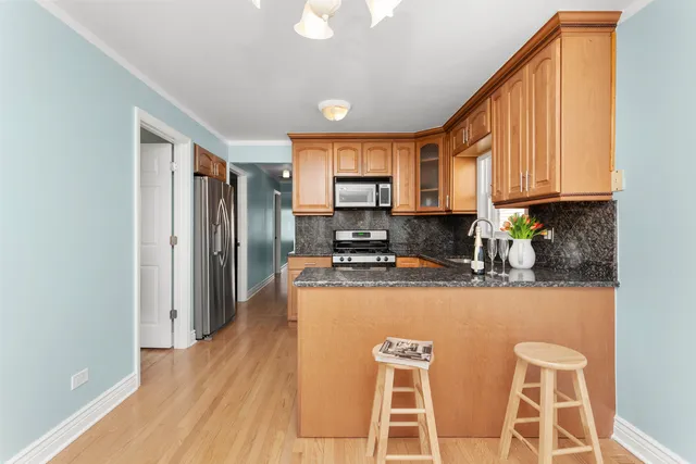 a kitchen with stainless steel appliances granite countertop a refrigerator a stove top oven a sink and dishwasher