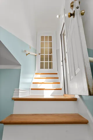 a view of staircase with white walls