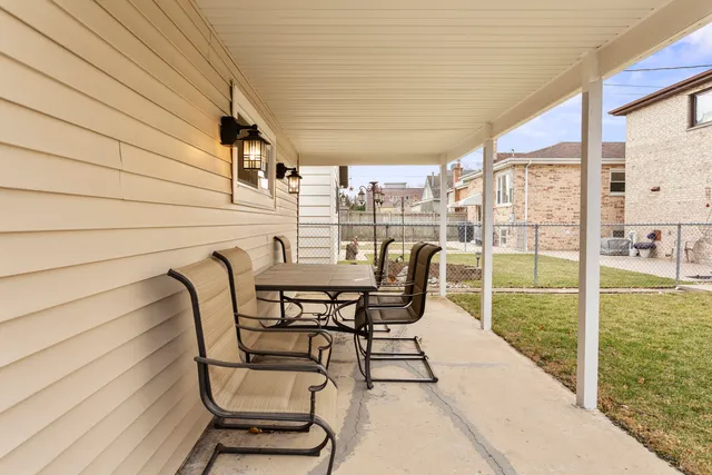 a patio with table and chairs