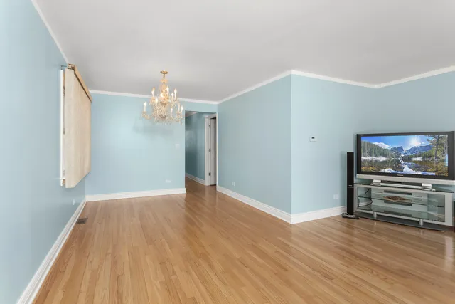 a view of kitchen and hallway with wooden floor