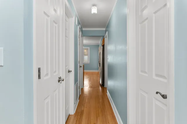 a view of a hallway with wooden floor