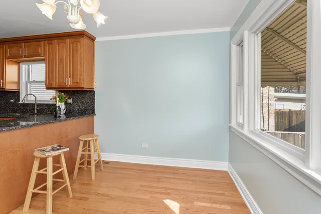 a workspace with wooden floor and a window