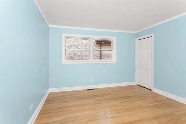 a view of a room with wooden floor and windows
