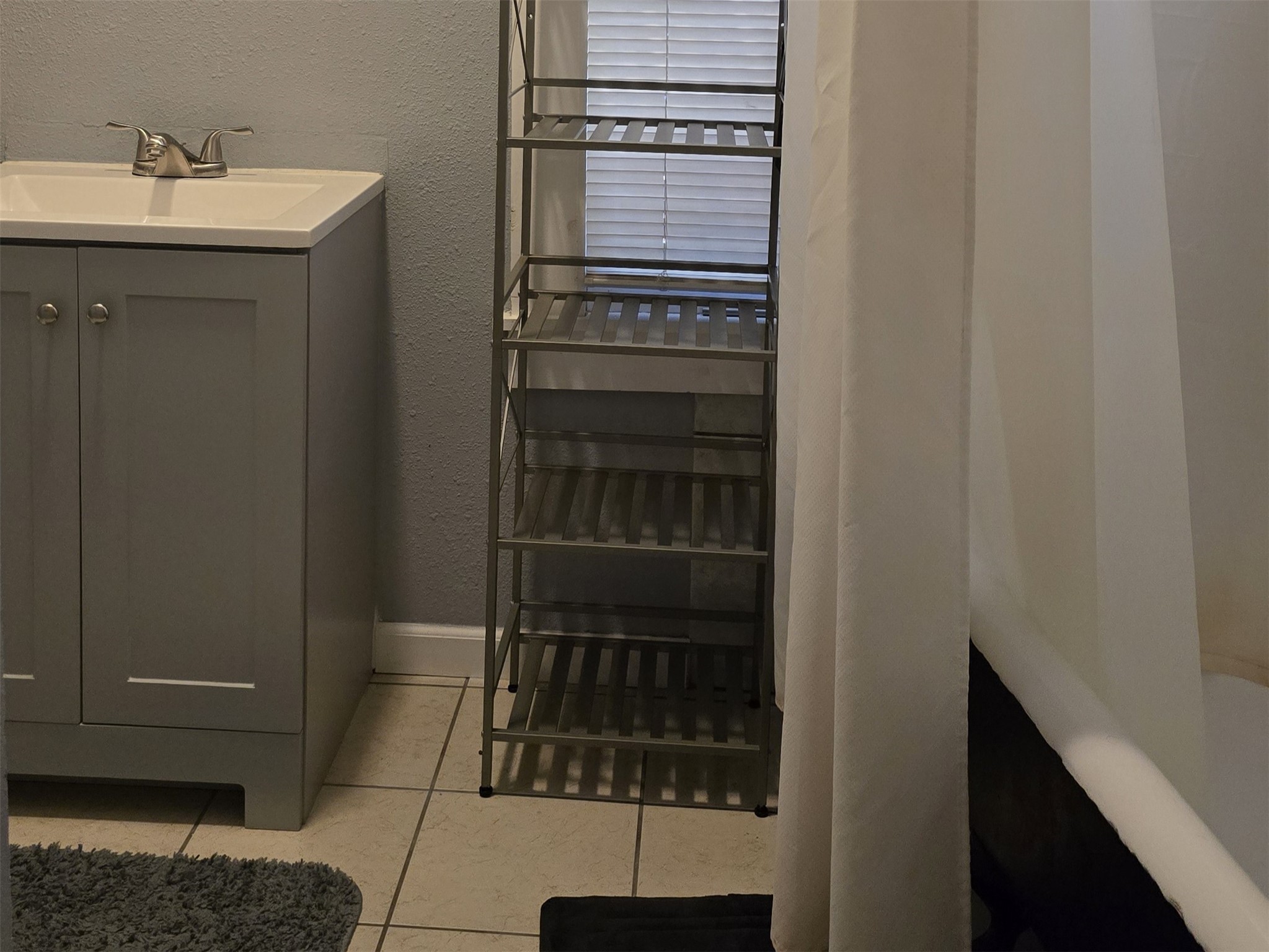 1614 Market Street, Unit 4 Galveston, TX 77550 - Photo 13 of 19 a bathroom with a sink and a mirror