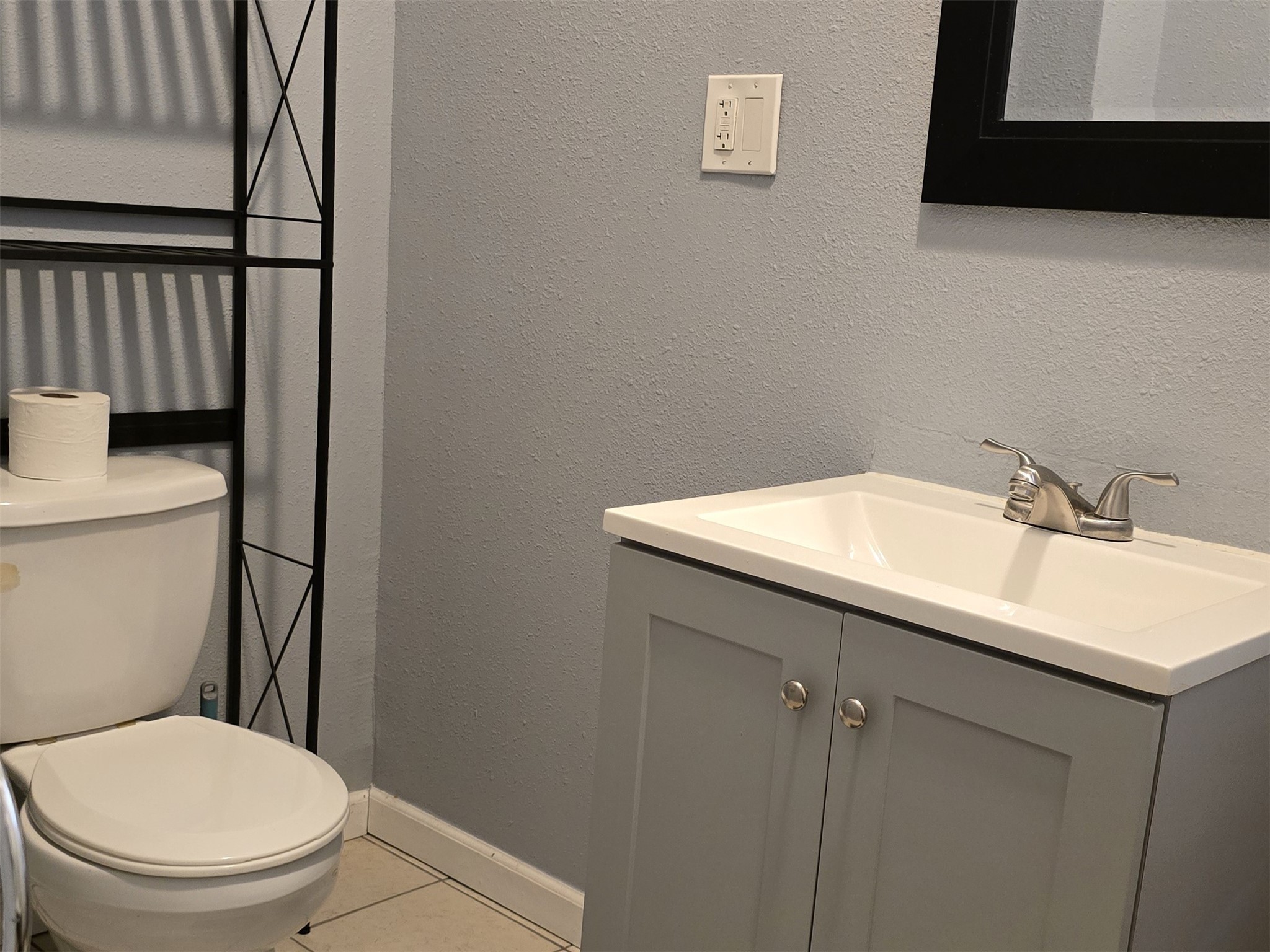 1614 Market Street, Unit 4 Galveston, TX 77550 - Photo 14 of 19 a bathroom with a sink toilet and mirror