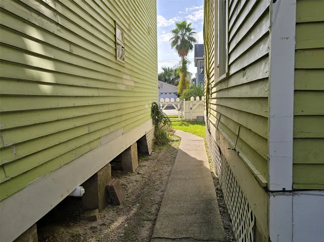 a view of a pathway with a wooden fence