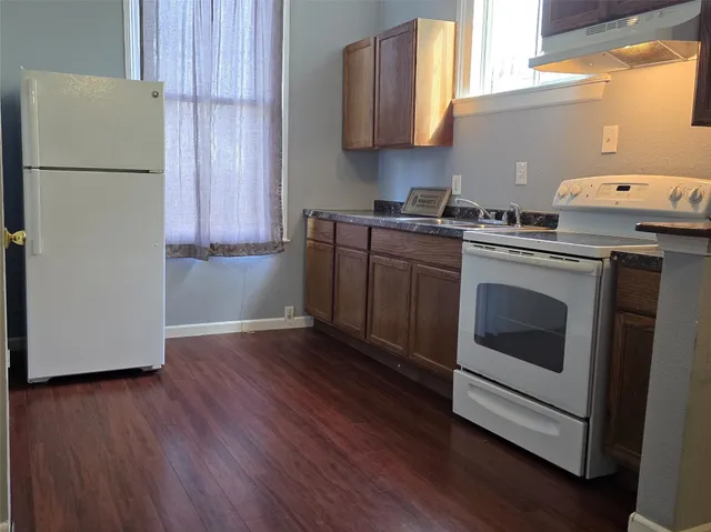 a kitchen with a white cabinets and white appliances