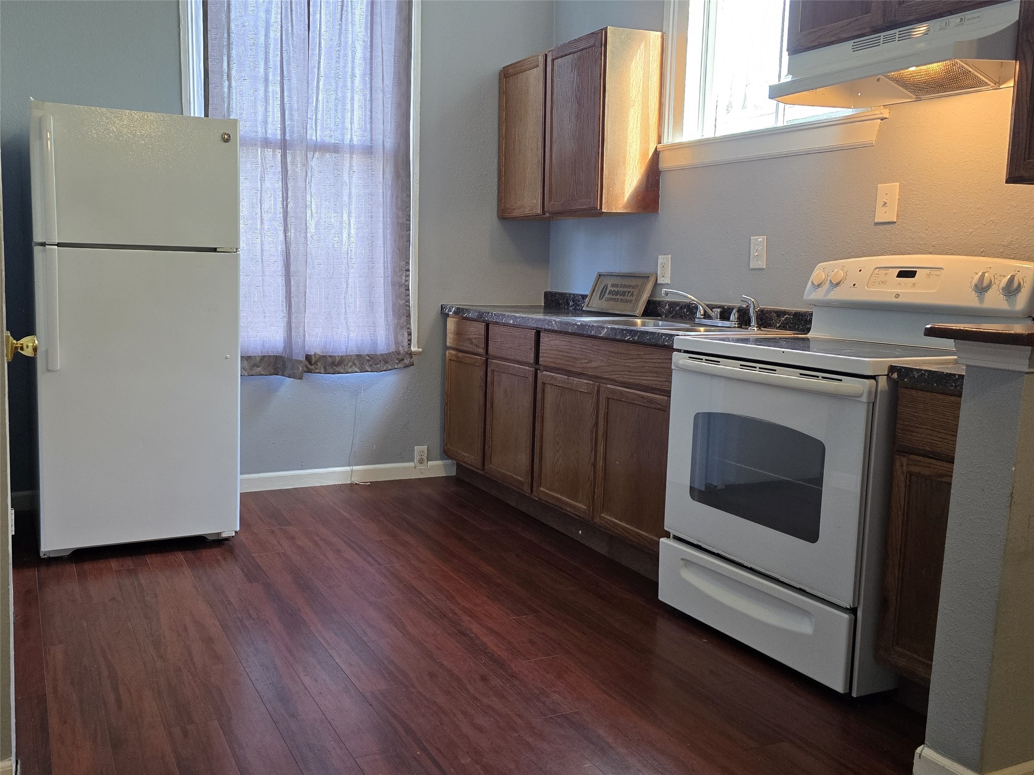 1614 Market Street, Unit 4 Galveston, TX 77550 - Photo 9 of 19 a kitchen with a white cabinets and white appliances
