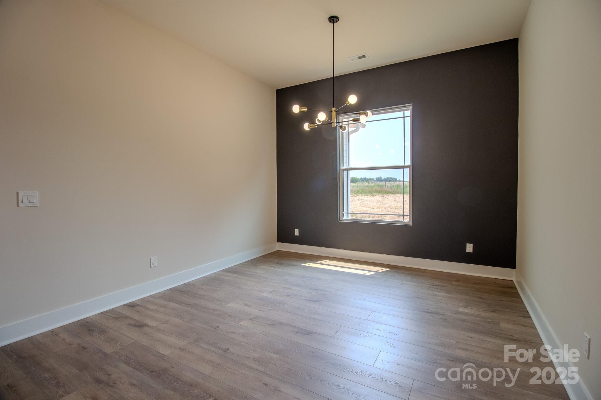 1429 Coppergate Drive Salisbury, NC 28147 - Photo 13 of 37 a view of an empty room with wooden floor and a window