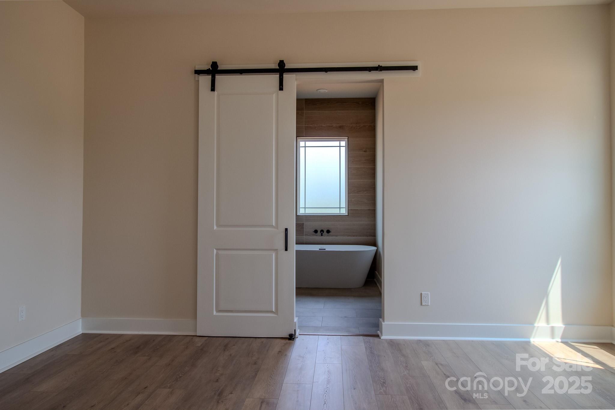 1429 Coppergate Drive Salisbury, NC 28147 - Photo 17 of 37 a view of a room that has a bed and wooden floor