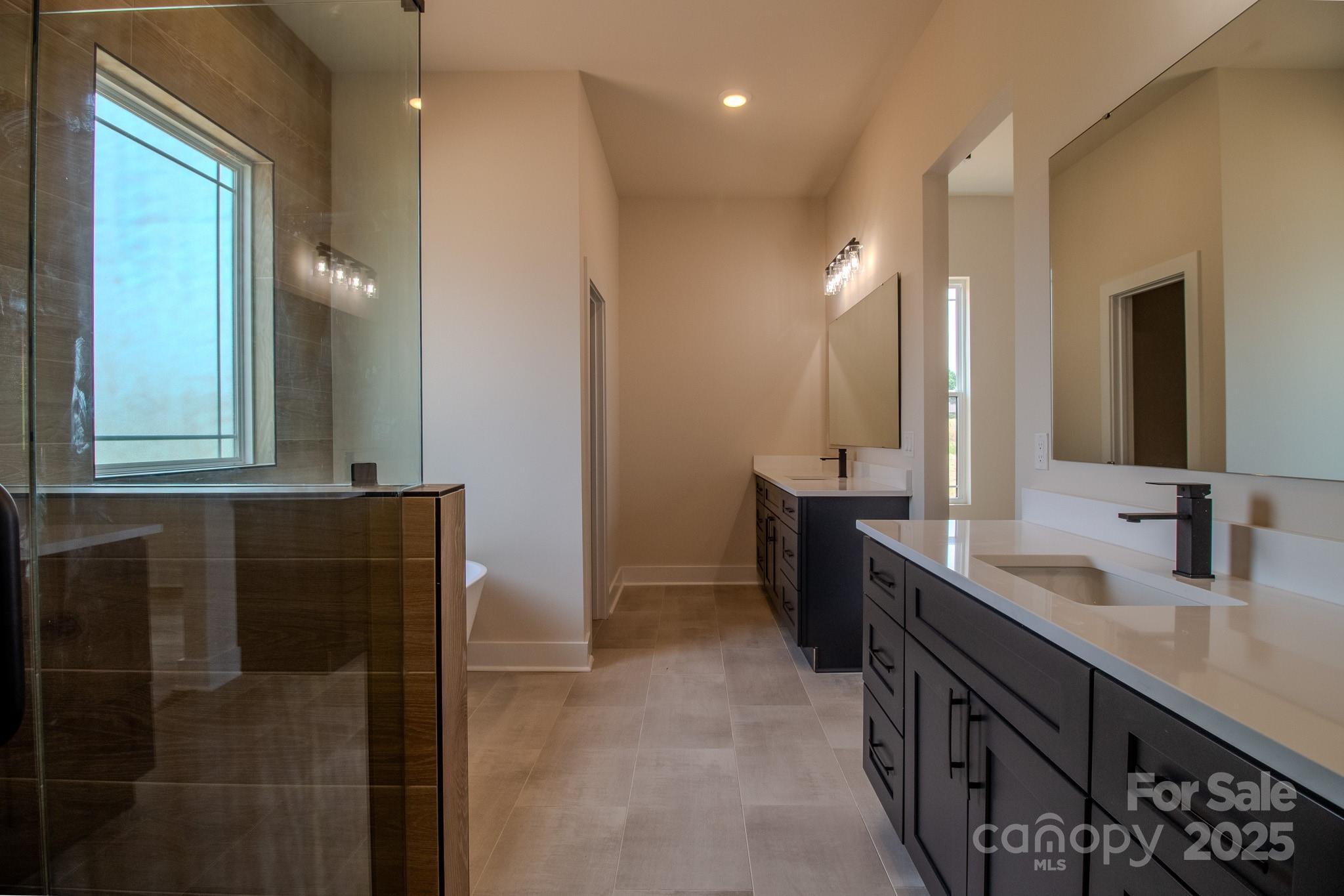 1429 Coppergate Drive Salisbury, NC 28147 - Photo 19 of 37 a bathroom with a double vanity sink a and a mirror