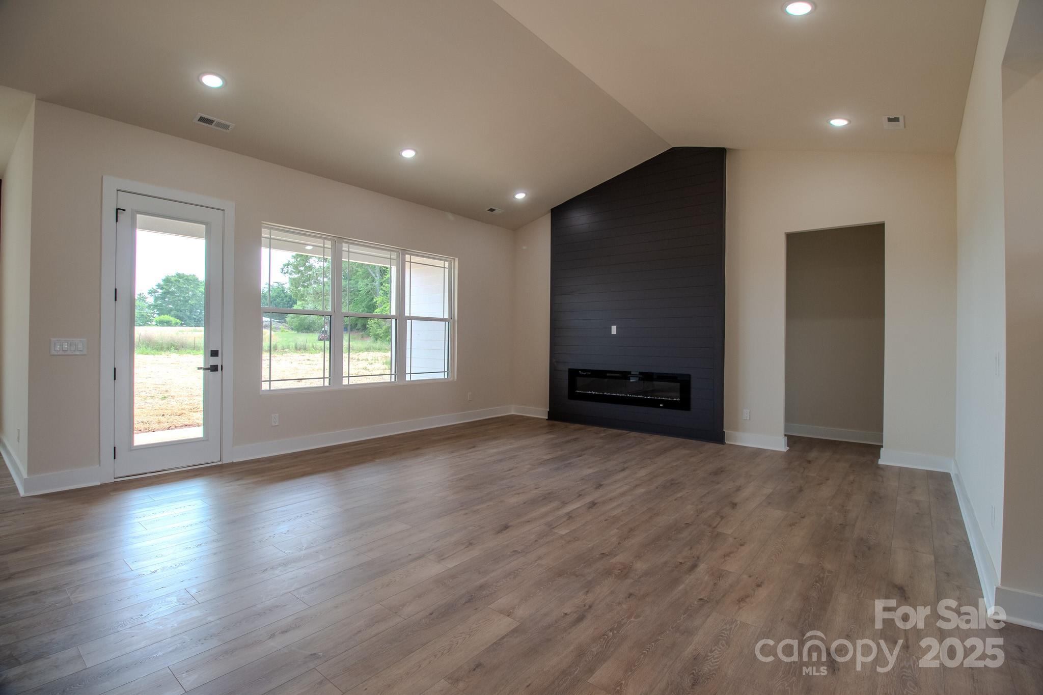 1429 Coppergate Drive Salisbury, NC 28147 - Photo 6 of 37 an empty room with wooden floor and windows